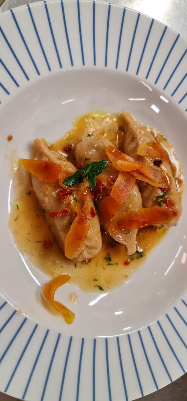 stewed culurgiones with bottarga flakes