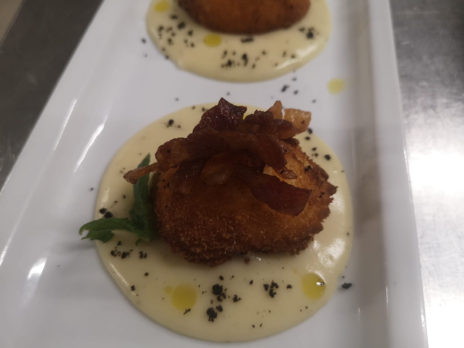 fritter garnished with crispy bacon