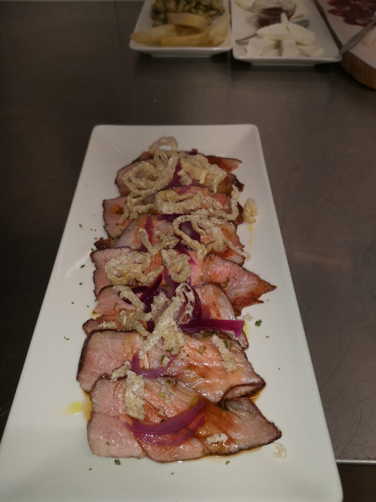 slices of roast meat with red onions