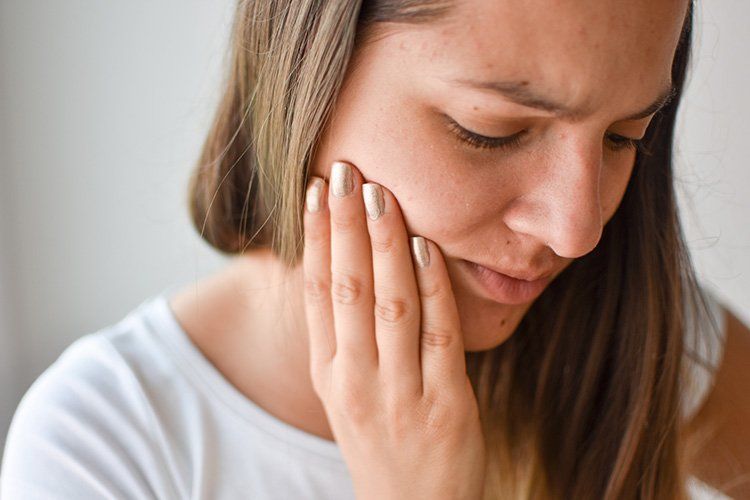 young woman with teeth pain