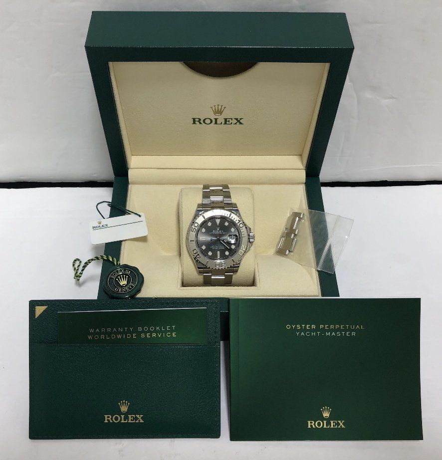 Rolex watch in its presentation box, with accompanying documents and tag.