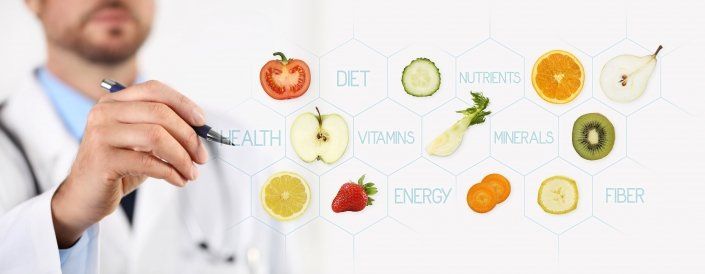 doctor pointing at various foods with pen
