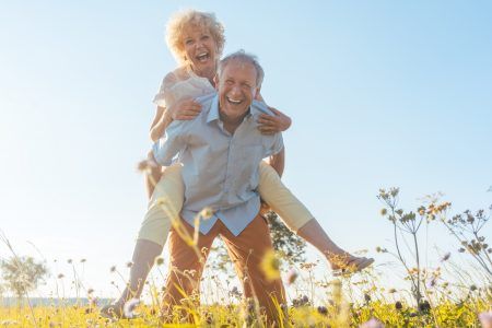 elderly couple having fun in the flowers