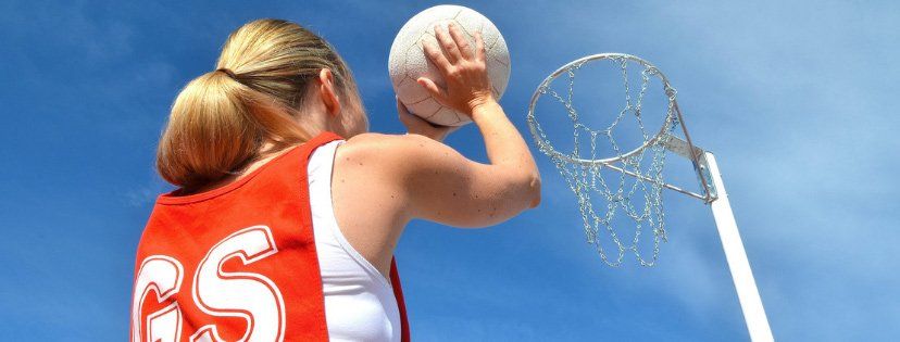 woman getting ready to throw ball in basket