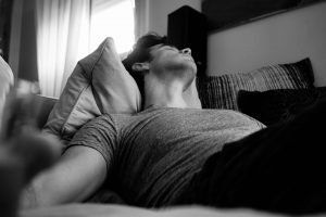 man laying down on couch