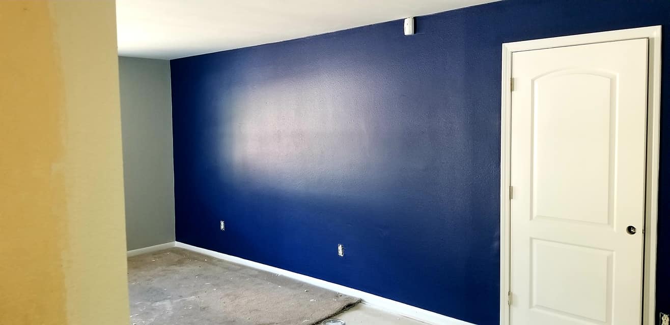 A room with blue walls and a white door.