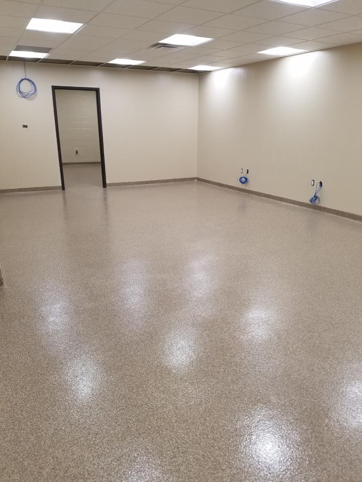 A large room with a shiny floor and white walls.