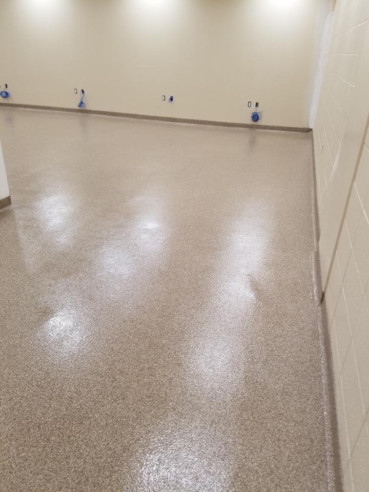 A large room with a shiny floor and white walls.