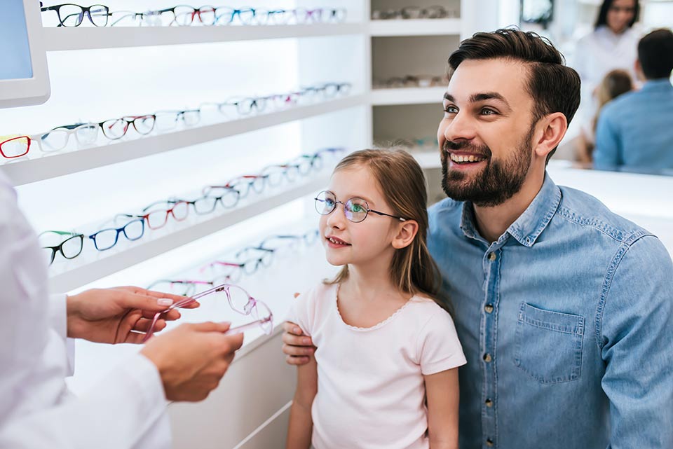 young girl trying on new eyewear