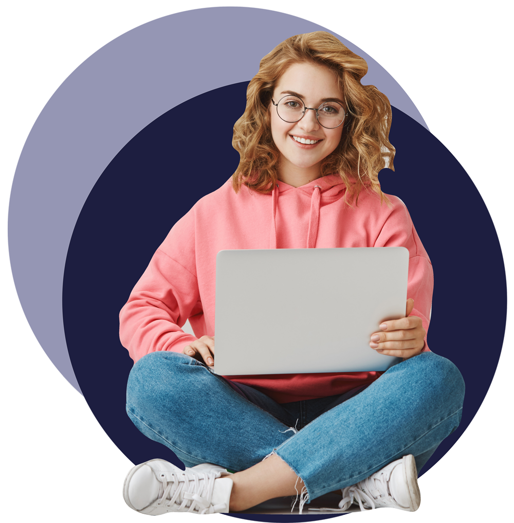 Woman smiling sitting down with laptop on her legs.