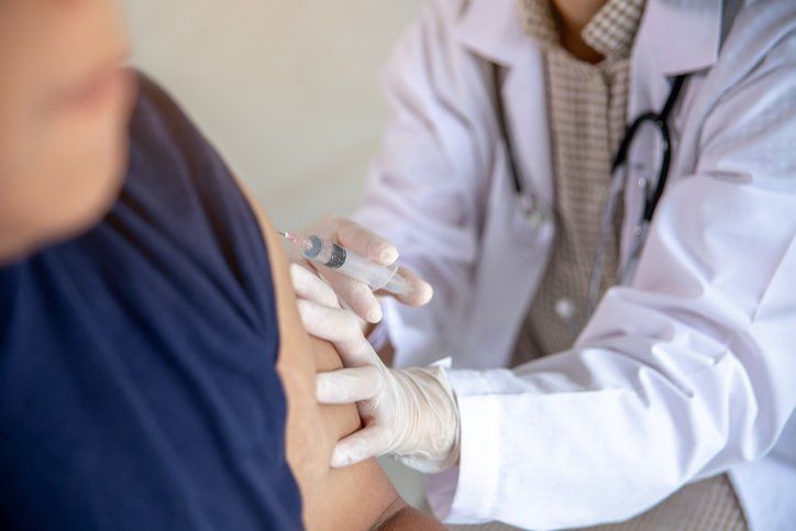 Man Receiving Flu Shot — Memphis, TN — Vaccine Injury Lawyers Man Receiving Flu Shot — Memphis, TN — Vaccine Injury Lawyers