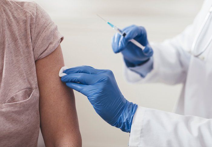 Doctor Injecting Vaccine to Man — Vaccine Injury Lawyers — Memphis, TN Doctor Injecting Vaccine to Man — Vaccine Injury Lawyers — Memphis, TN