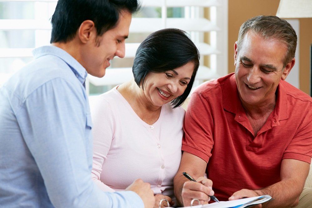 Senior Couple Signing a Document — Wausau, WI — Attorney Rhonda R Werner Schultz LLC Senior Couple Signing a Document — Wausau, WI — Attorney Rhonda R Werner Schultz LLC