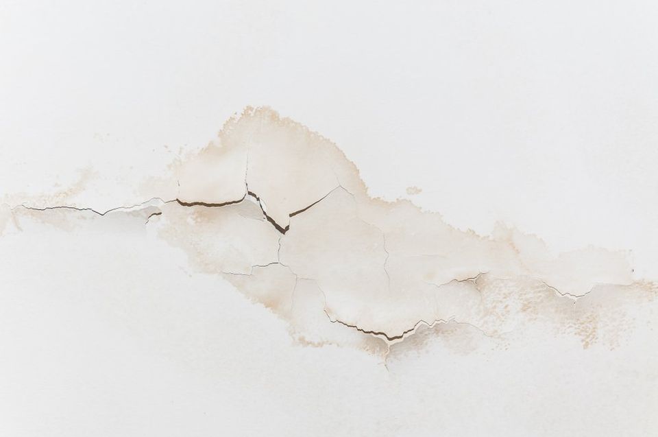 Water stains and cracks visible on a white wall - Restoration 1 of Summit