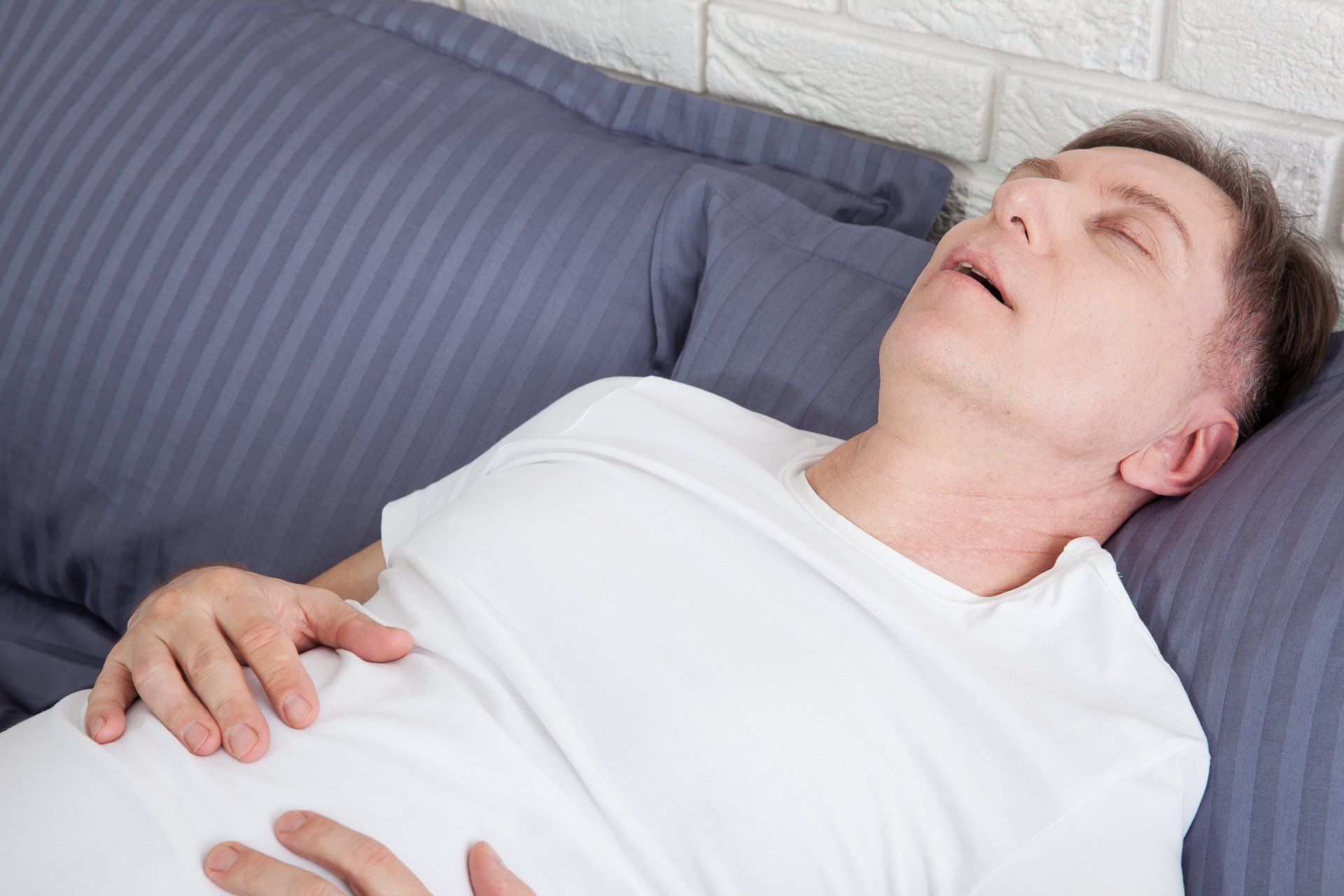 man with sleep apnea snoring
