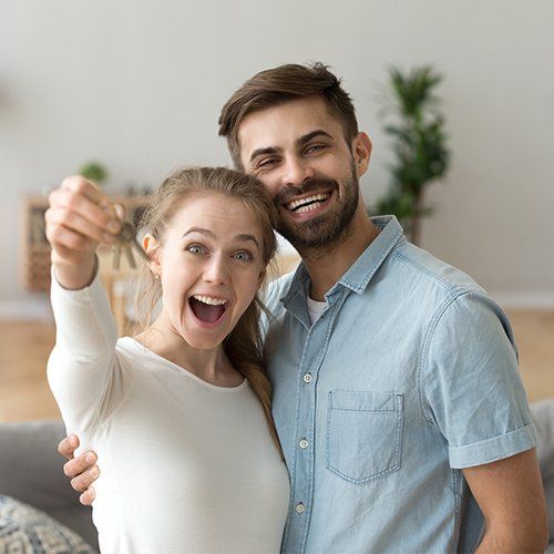 Couple Standing in Living Room — Cape Coral, FL — Ordonez Realty Couple Standing in Living Room — Cape Coral, FL — Ordonez Realty