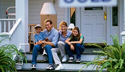 Happy Family in Front of Their House - Home Insurance in Siley City, NC Happy Family in Front of Their House - Home Insurance in Siley City, NC