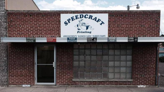 A brick building with a sign that says speedcraft