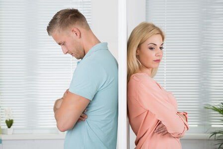 Unhappy Couple Standing Back To Back At Home - Attorney Office in Jonesboro, AR Unhappy Couple Standing Back To Back At Home - Attorney Office in Jonesboro, AR