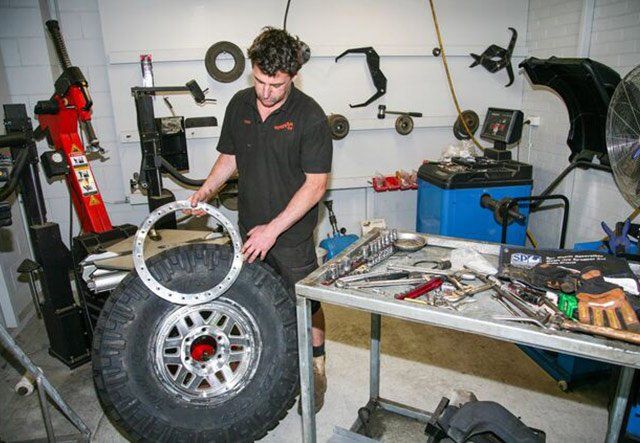 man working on tire