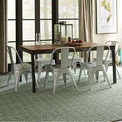 Modern dining room with a wooden table, white chairs, and large windows