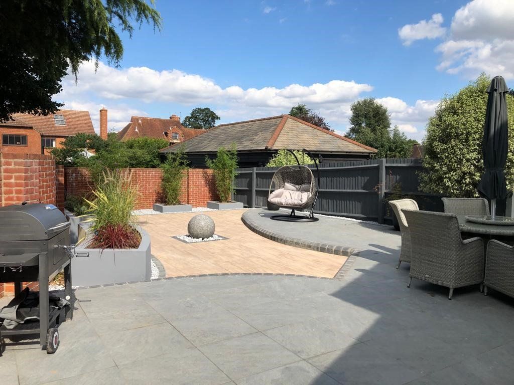 There is a water feature in the middle of the backyard.
