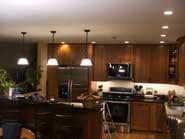 Kitchen with wooden cabinets, stainless steel appliances, and pendant lights.