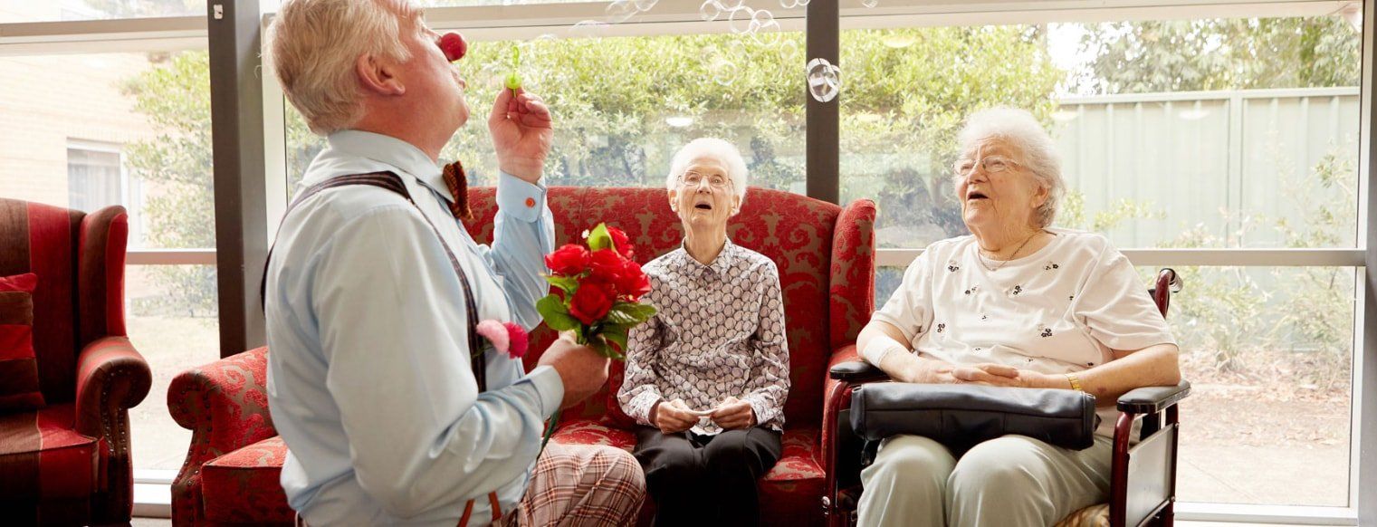 A person entertaining two older women