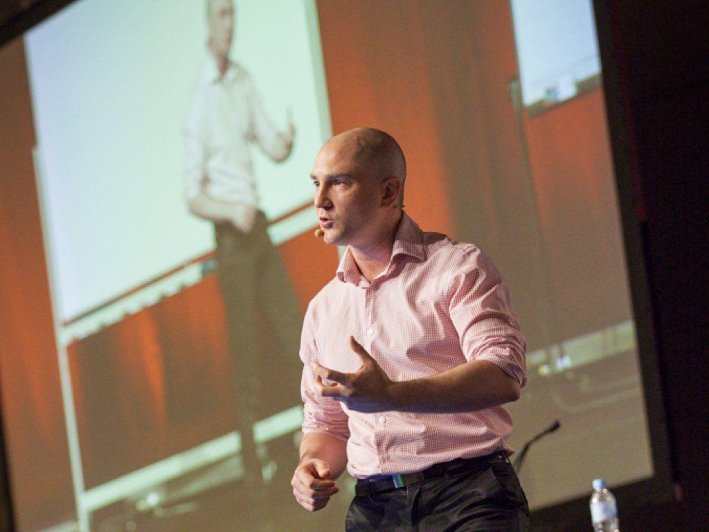 Ashton Bishop on stage giving a presentation