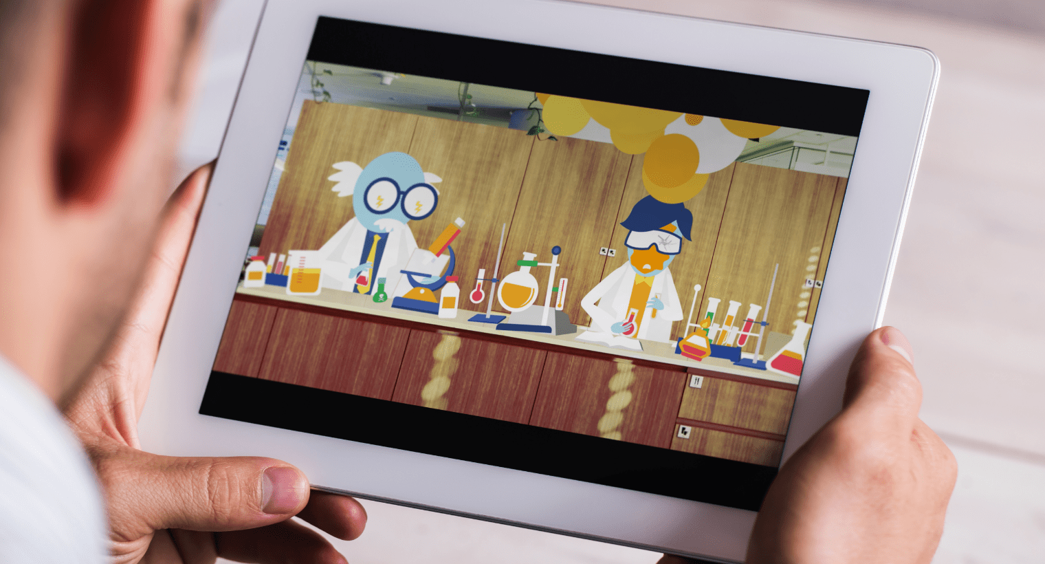 Someone watching a video of the AGL illustrated characters on a tablet