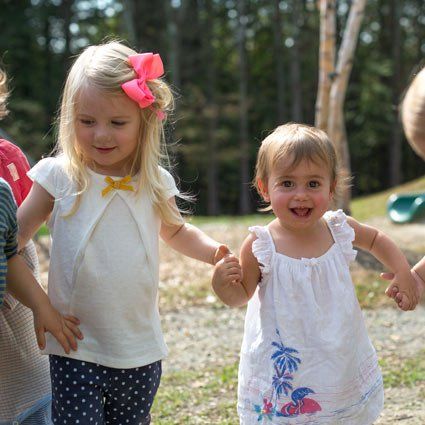 smiling children holding hands
