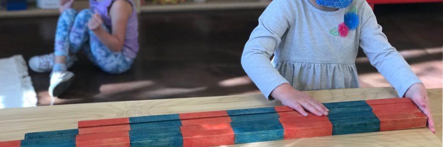 Preschool aged child with units bars on a table