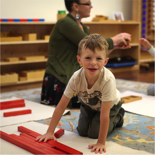 Smiiling child with units blocks