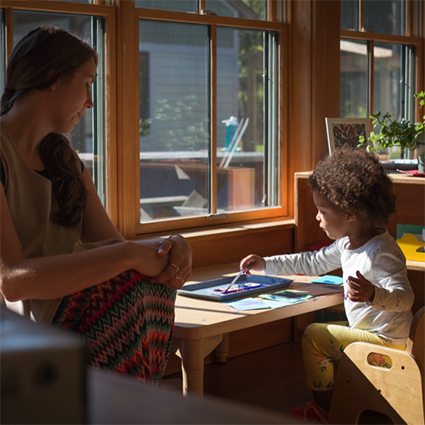 Toddler with guide at painting lesson