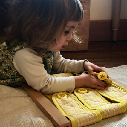 Toddler with buttons dressing frame