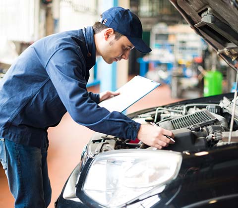 Mechanic at Work in His Garage — Redmond, WA — Redmond Werkshop Inc Mechanic at Work in His Garage — Redmond, WA — Redmond Werkshop Inc
