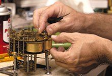 Clock Supplies — Worker Fixing Clock Part in Wayland, MA Clock Supplies — Worker Fixing Clock Part in Wayland, MA