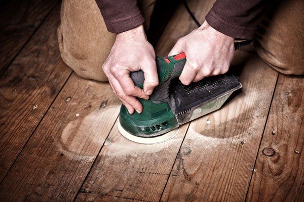 photo of a floor being sanded