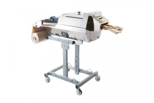 A machine is sitting on a cart with a white background.