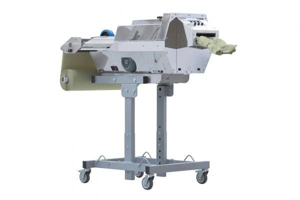 A machine is sitting on a stand with wheels.