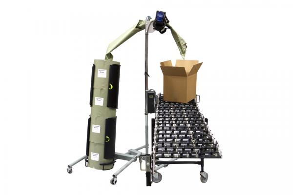 A robotic arm is lifting a cardboard box on a conveyor belt
