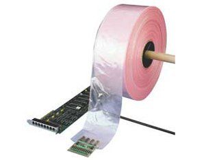 A roll of pink duct tape is sitting next to a motherboard.