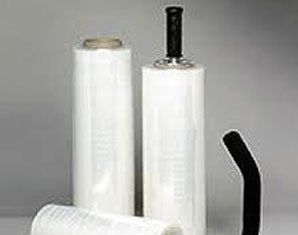 Three rolls of plastic wrap with handles are sitting on top of each other on a table.