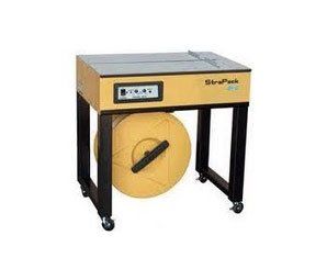 A machine that is sitting on a table with a roll of tape on it.