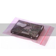 A hard drive is sitting on top of a pink anti static sealtop bag.