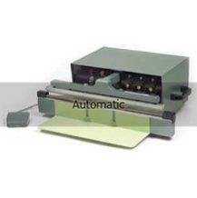 A machine that is sitting on a table with a piece of paper on it.