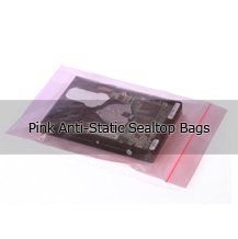 A hard drive is sitting on top of a pink anti-static sealtop bag.