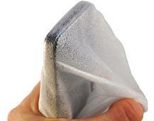A person is holding a piece of plastic in their hand.