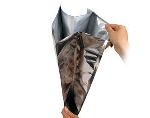 A person is holding a silver bag in their hands