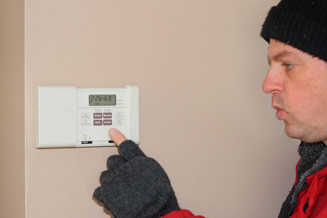 Man Adjusting the Aircon — Boise, ID — Northwest Heating & Air Conditioning Inc